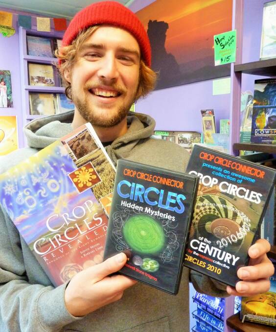 Tenzin Butt with some of the crop circle merchandise available in Central Tilba's Gulaga Gallery and Bookshop. Photo: Tim the Yowie Man