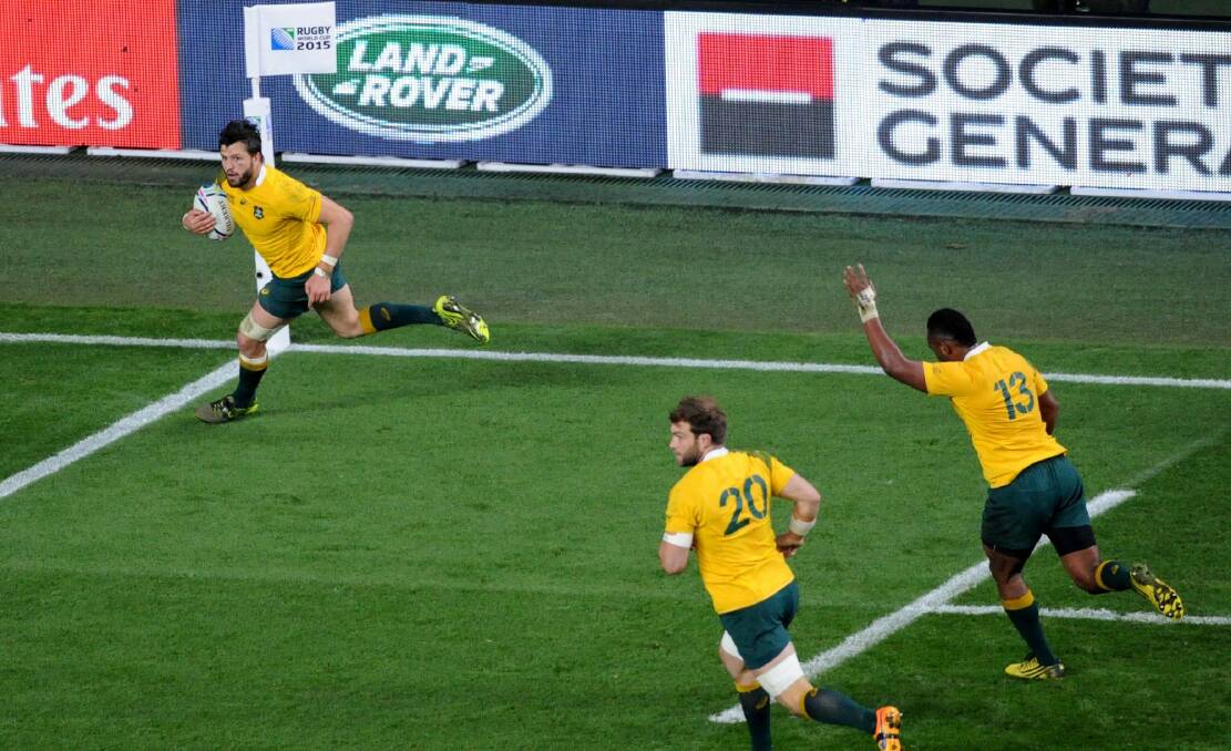 Ball game: Adam Ashley-Cooper crosses for his third try of the match after Drew Mitchell's pass. Photo: AP