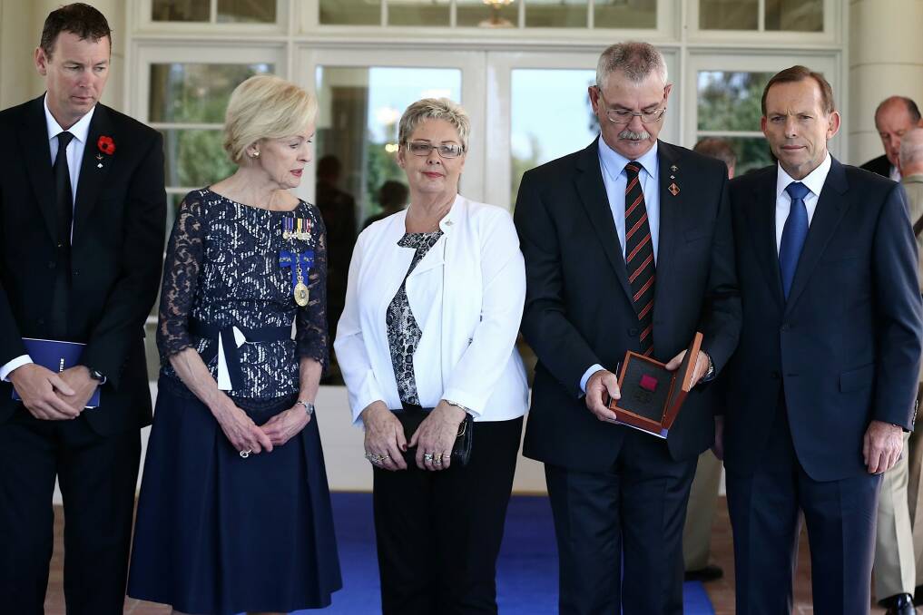 Doug and Kaye Baird are presented with a Victoria Cross for their late son Corporal Cameron Baird VC MG by Governor-General Quentin Bryce with Prime Minister Tony Abbott in February. Photo: Alex Ellinghausen