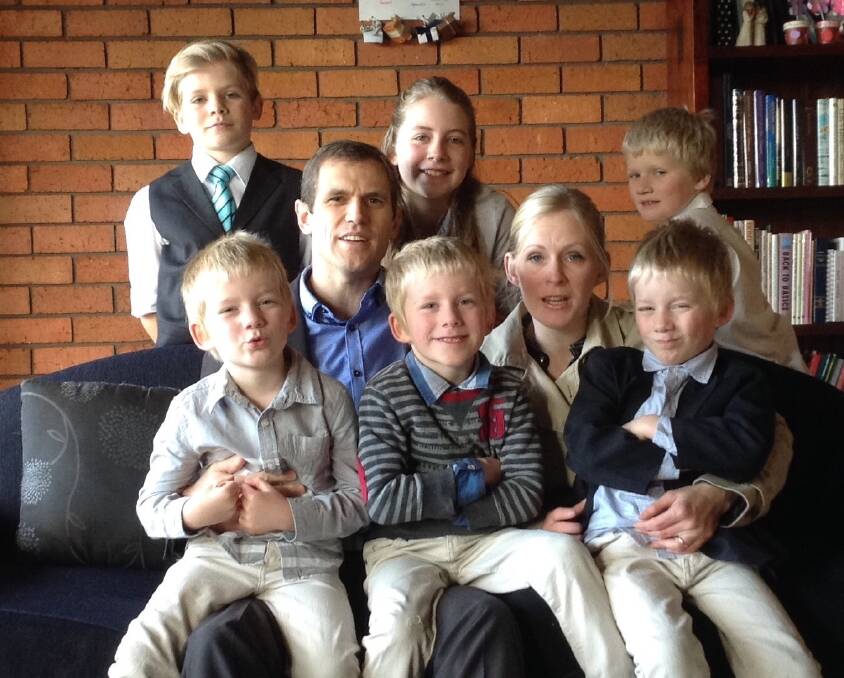 Former Canberra couple Shaun and Elena Thayer at home in Hobart with their children (back) Jacob, Elissa and Samuel and triplets, Benjamin, Isaac and William. The triplets, now 5, were on the front page of The Canberra Times in 2011, three weeks after they were born. Photo: Supplied