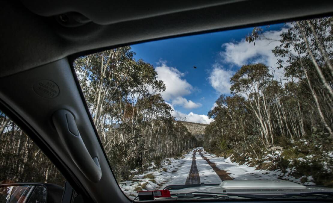 Transport Canberra and City Services Project Officer Adam Melville looks after icy or snow affected roads in the Namadgi National Park area (near the Mount Franklin chalet site). Photo: karleen minney
