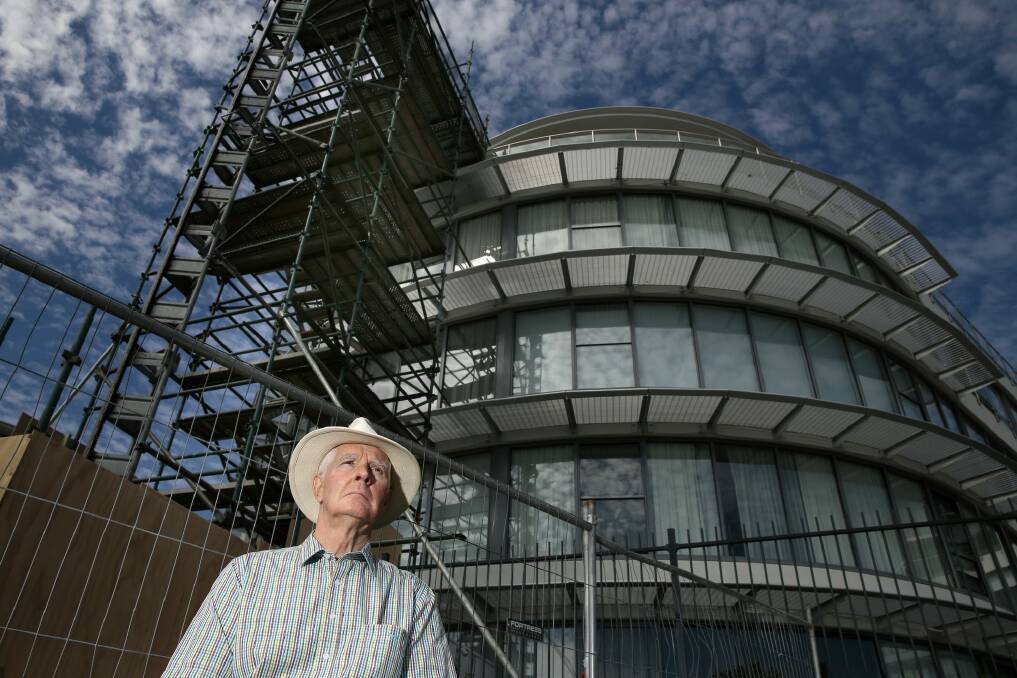 Owners Corporation Network ACT president Gary Petherbridge in front of scaffolding for repair work on a block of apartments at the Kingston Foreshore. Photo: Jeffrey Chan