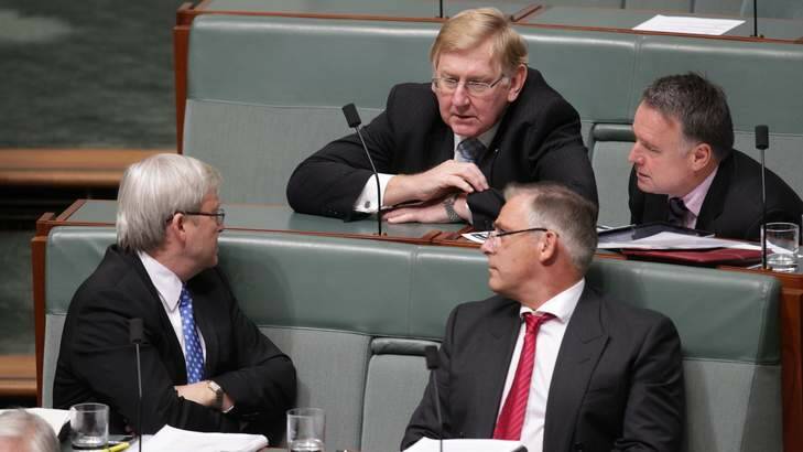 Labor MP Kevin Rudd in discussion with backbenchers during Question Time, at Parliament House. Photo: Alex Ellinghausen