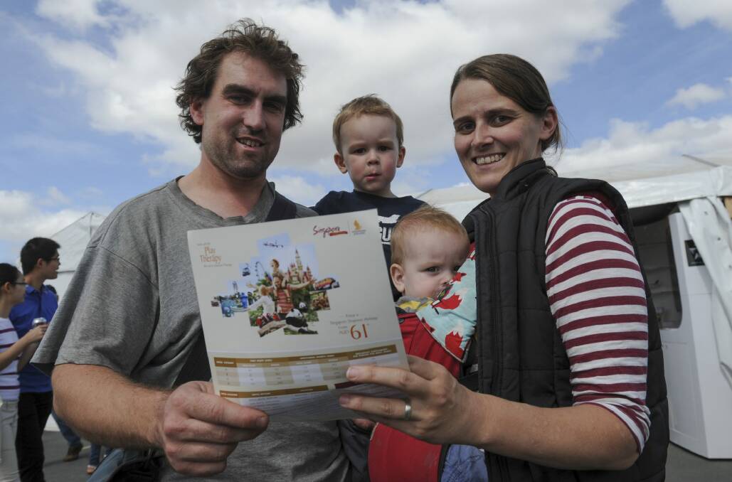 Looking to buy direct flight tickets to Singapore with Singapore Airlines are Alex and Carrie Powick, of Higgins, with their children Oscar 2 and Thomas 10 months. Photo: Graham Tidy
