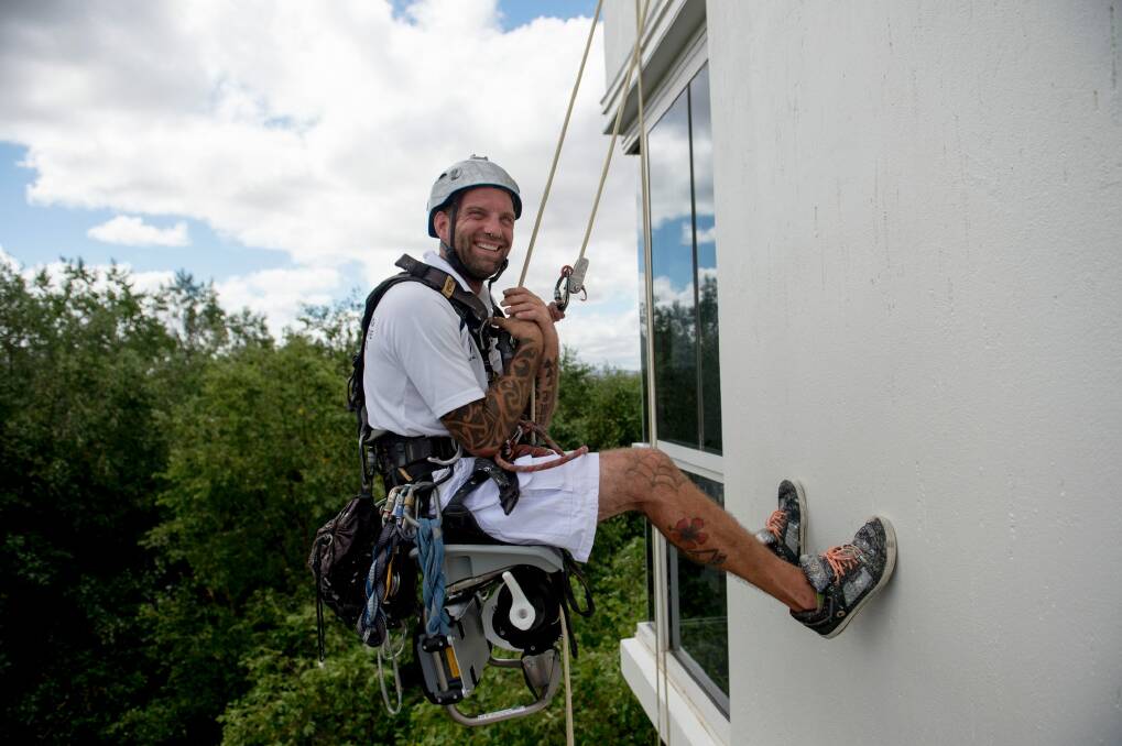 Hanging off the Landmark apartments in Barton on Wednesday was Stefano Dubbiosi from CPR Painting. He  trains the painters to abseil and is also a keen yachtie, usually hanging off a mast. Photo: Jay Cronan