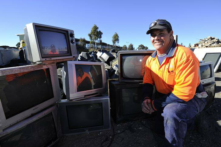 Mitchell Transfer Station's Doug Bailey with the old TVs that have been dropped off to be recycled. Photo: Jay Cronan