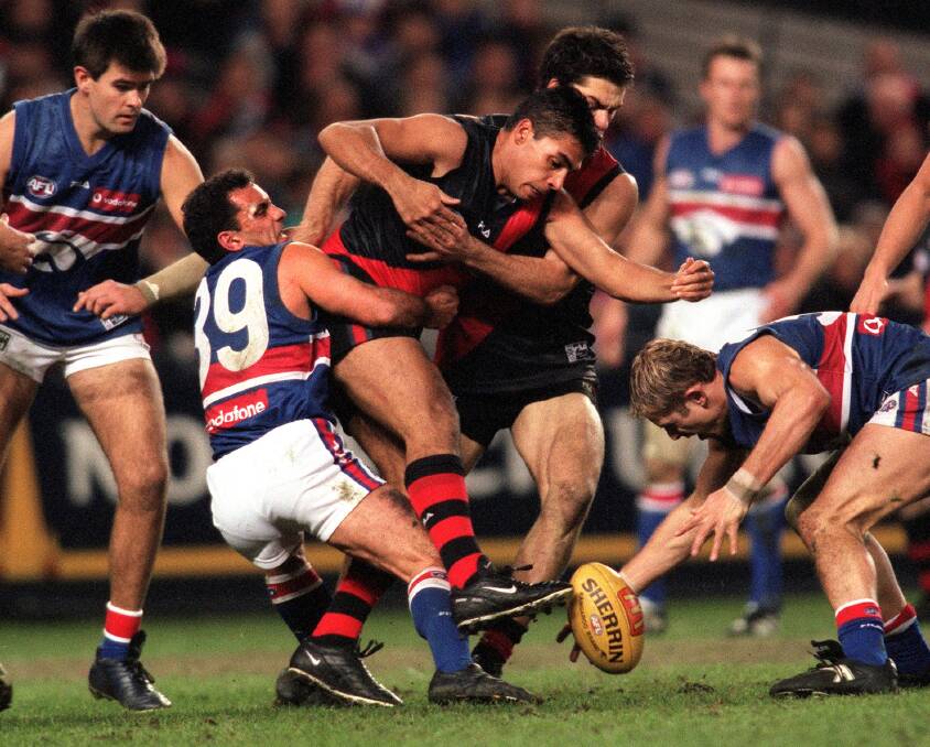 vjc000728.003.012

Pic Vince Caligiuri , The Age Melbourne

Western Bulldogs v Essendon , Colonial stadium...Tony Liberatore at his best with his fearsome tackling , this time he pins Essendons Dean Rioli

2000 AFL (Australian Football League) - Round 21- Essendon  versus  Western Bulldogs - Colonial Stadium Photo: Vince Caligiuri