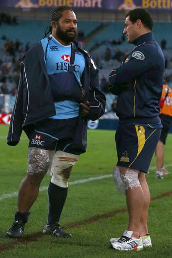 Injured players Tatafu Polota-Nau of the Waratahs and George Smith of the Brumbies speak on the field after the round 14 Super Rugby match. Photo: Mark Kolbe