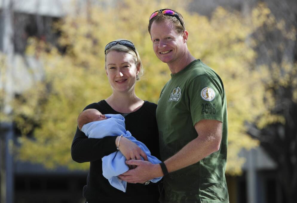 Kambah couple Leanne and Drew Salzke  with their third son, three-week-old Jack.  Photo: Graham Tidy