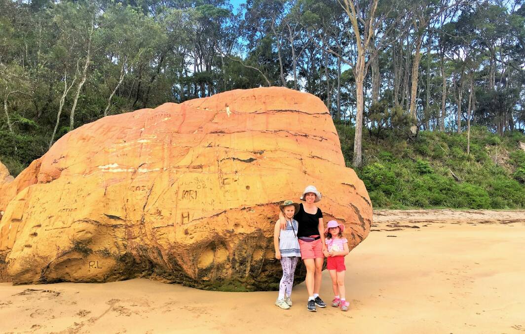 The Yowie girls visit the big boulder on Quiriga Beach. Photo: Alan Nichol