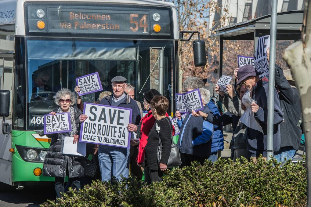 Residents of Goodwin Retirement Village and supportive neighbours in Crace hold a silent demonstration to protest the government’s proposed changes to their bus route. They briefly stepped out in front of the 11.22am bus. Photo: Karleen Minney