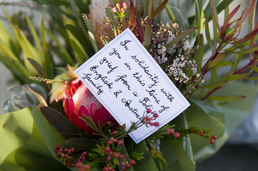 Flowers left at the front door of the French Embassy in Canberra. Photo: Jay Cronan