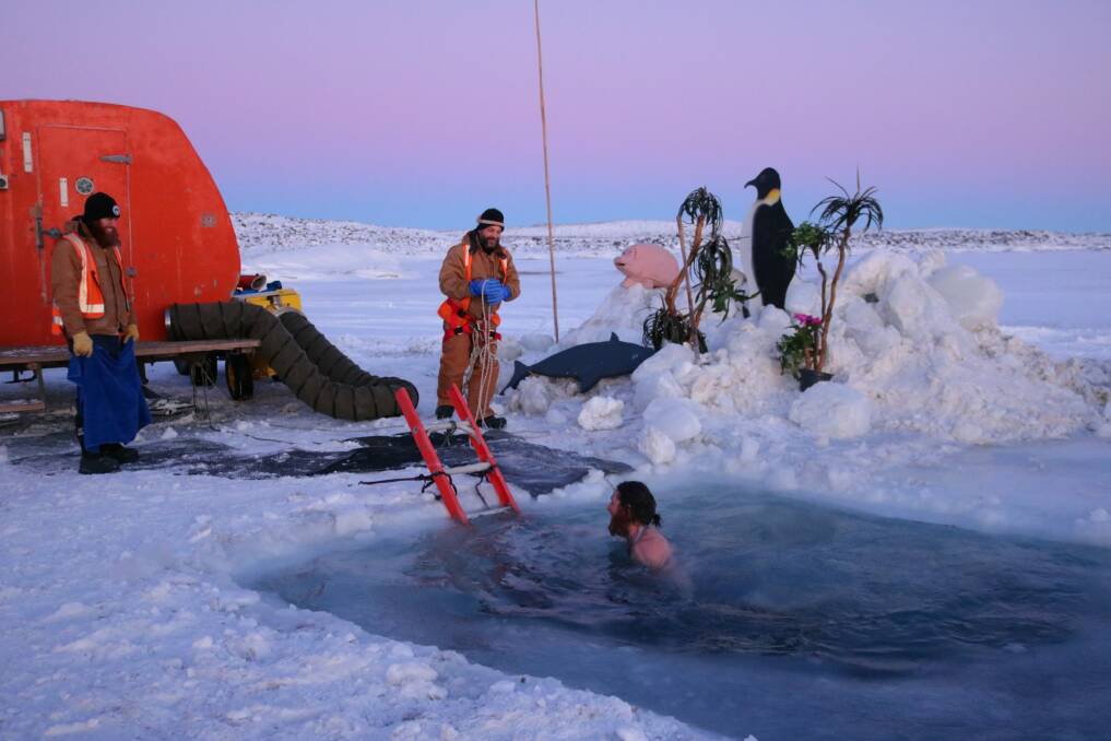 Australians stationed at Antarctica's Davis station celebrate midwinter with an icy dip. Photo: Supplied