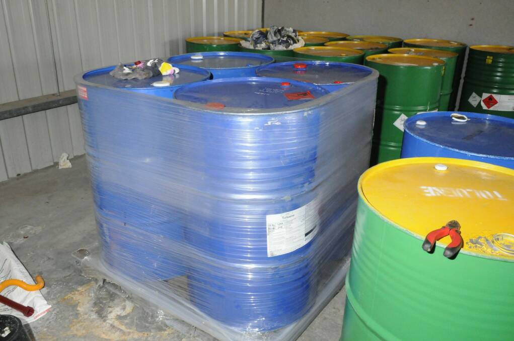 Chemicals drums found inside Hume unit used as a drug lab to manufacture MDMA. Photo: Supplied