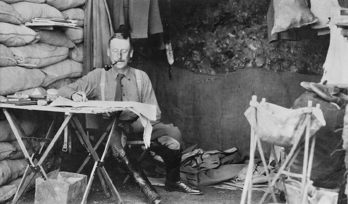 Lieutenant Colonel Cyril Brudenell Bingham White, Chief of Staff to the commander of the Australian Imperial Force, Lieutenant General Birdwood, works at a folding table at the entrance of his dugout at Gallipoli.