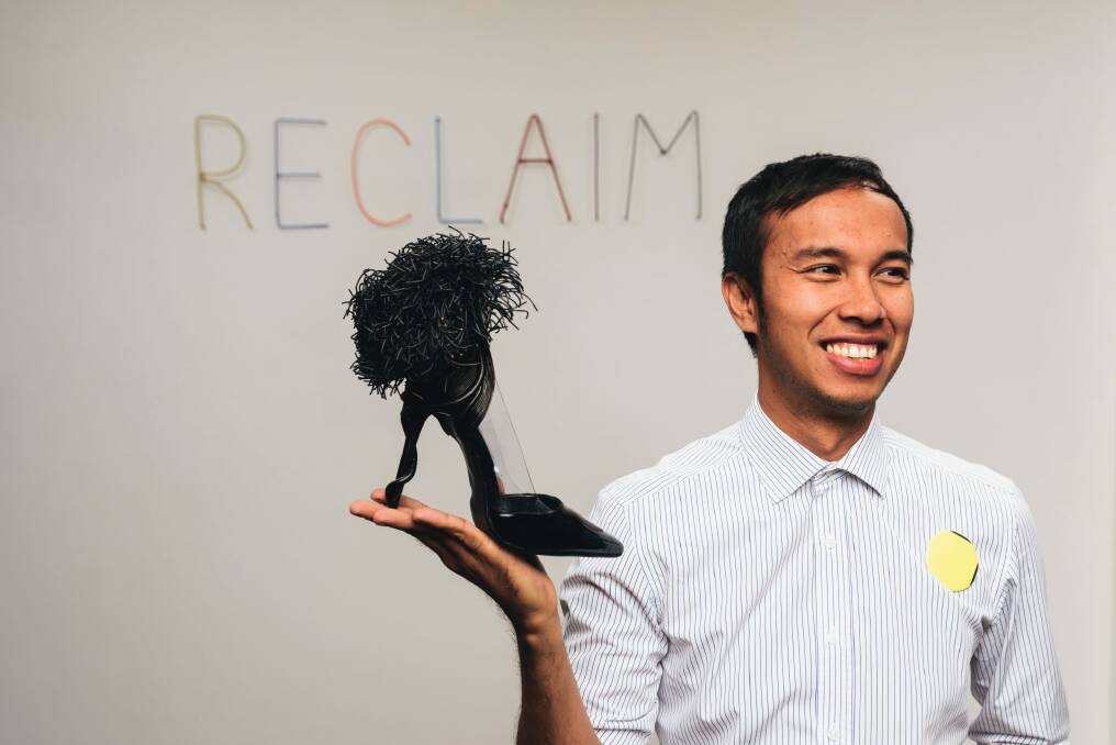 Couture trashion artist Francis Sollano from the Philippines with a shoe, one of the pieces he has on show in the Reclaim exhibition as part of Design Canberra. Photo: Rohan Thomson