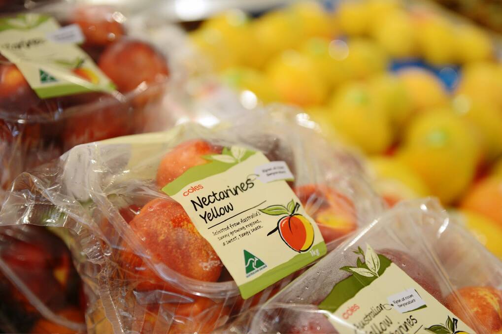Store brand packages of nectarines are displayed for sale in the produce section. Photo: Carla Gottgens