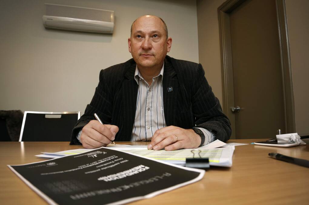 A-League4Canberra bid leader Ivan Slavich writes out refund cheques for people who supported the bid. Photo: Jeffrey Chan