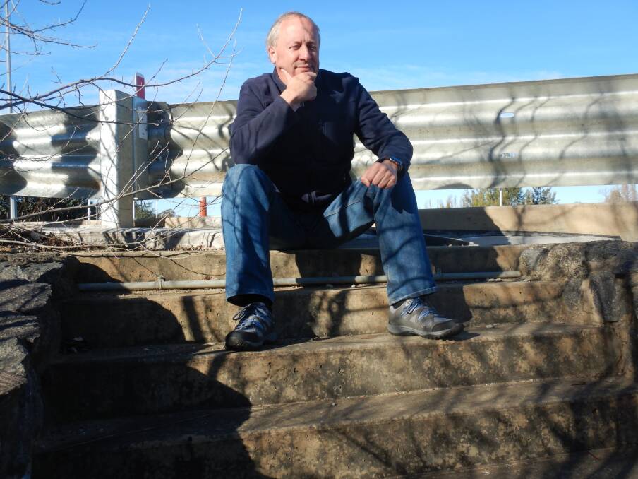 Thomas Schulze sits atop the stairs to nowhere at Malcolm Fraser Bridge. Photo: Tim the Yowie Man