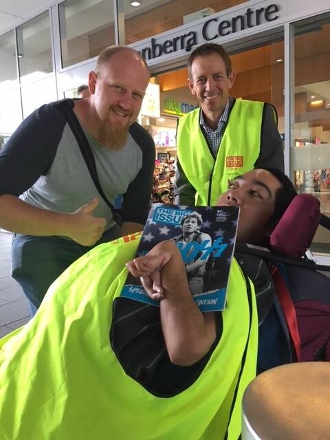 Greens MLA Shane Rattenbury sells The Big Issue with vendor Tau (right) while getting the thumbs up from a prospective customer. Photo: Supplied