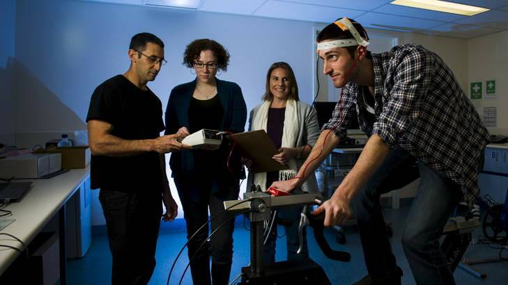 Assistant professor Stuart Cathcart, with UC psychology honors students, Mylie Sell and Lisa Shirt, take transcranial direct-current stimulation readings from fellow student Andrew Flood. Photo: Rohan Thomson