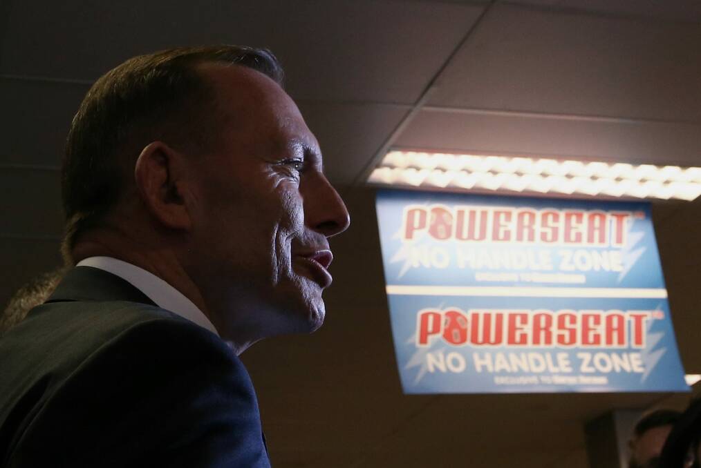 Prime Minister Tony Abbott, during their visit to Harvey Norman in Canberra, said his focus was on passing key budget measures. Photo: Alex Ellinghausen