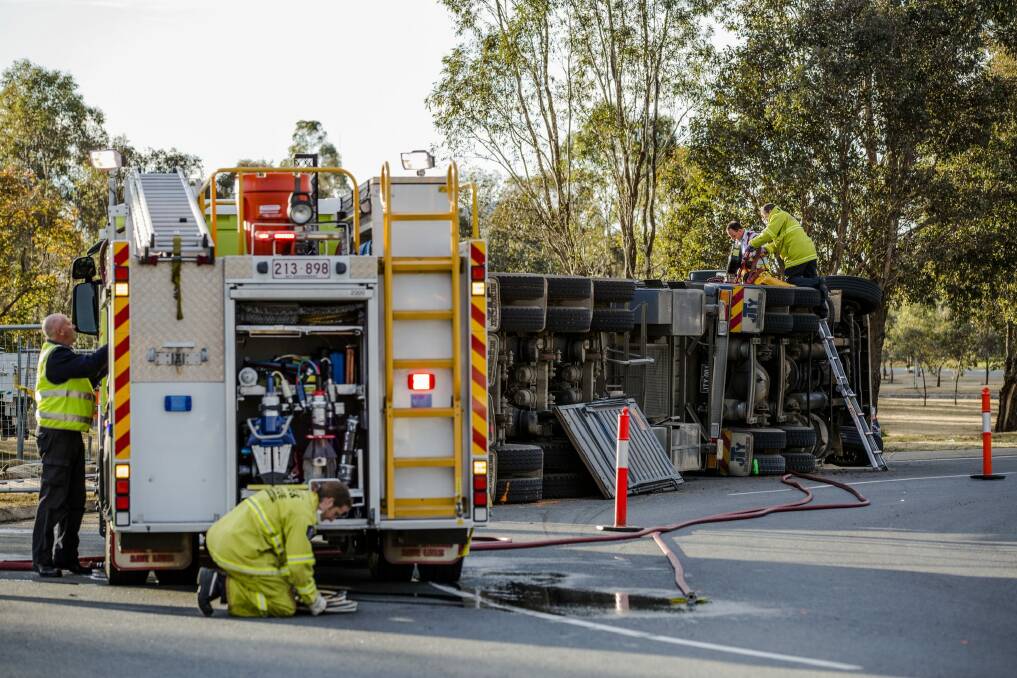 Emergency service crews work at the scene of a truck crash on Drakeford Drive. Photo: Jamila Toderas