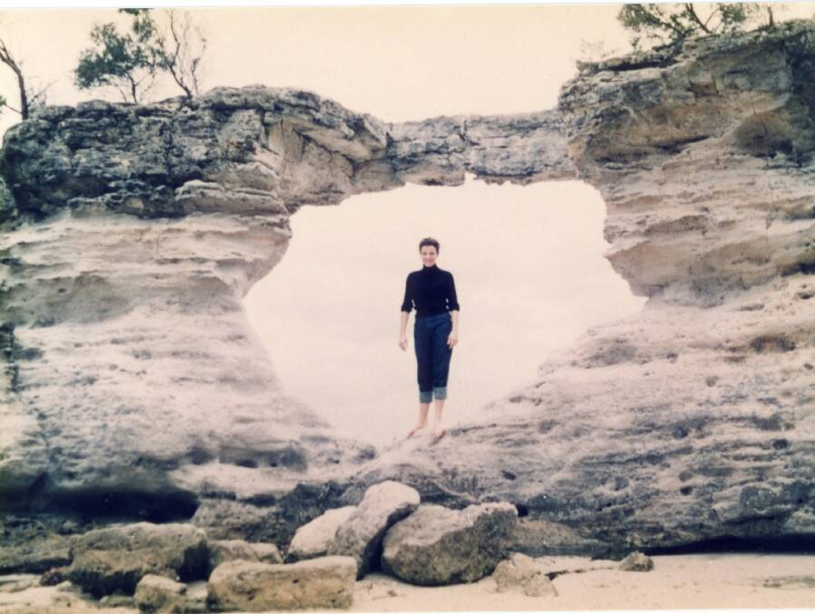 A lady poses for a photo at the Hole in the Wall, circa 1960. Photo: Jervis Bay Maritime Museum