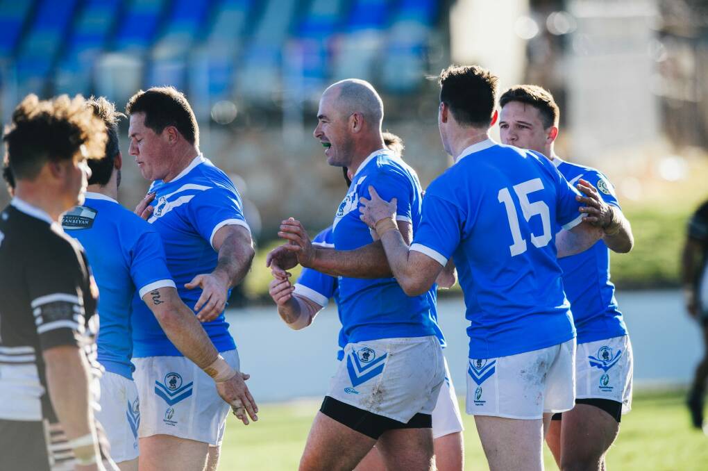 Terry Campese (centre) celebrates a Queanbeyan try with teammates in the Blues' Canberra Raiders Cup preliminary final win over the Yass Magpies on Sunday. Photo: Rohan Thomson