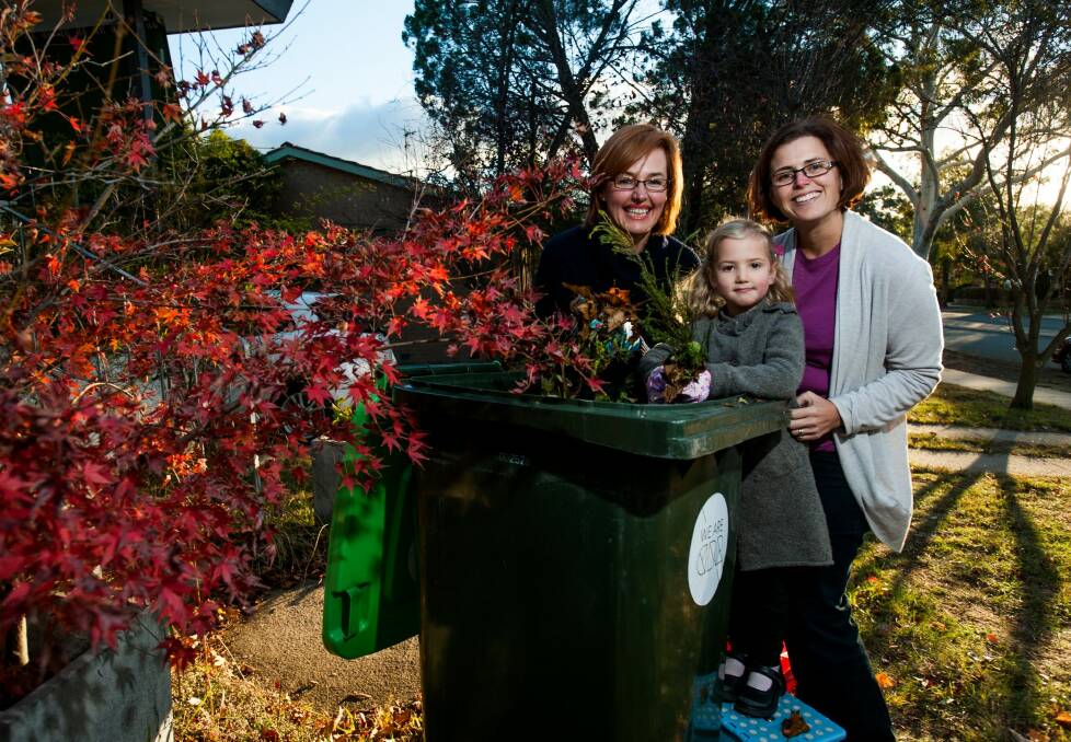 Municipal Minister Meegan Fitzharris (left) with Weston Creek residents Cath Collins and Cath's daughter Sammi. Ms Fitzharris says Labor has changed its position on providing garden waste bins. Photo: Elesa Kurtz