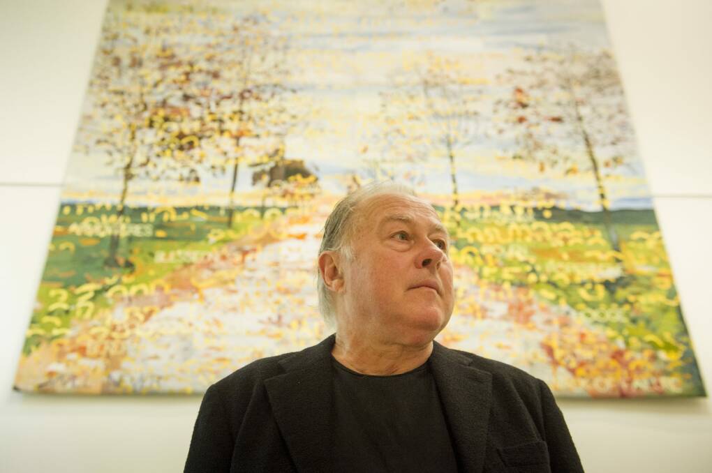 Artist Imants Tillers stands in front of the latest artwork to adorn the walls of the Australian War Memorial, a commemorative tapestry based one of his paintings. Photo:  Jay Cronan