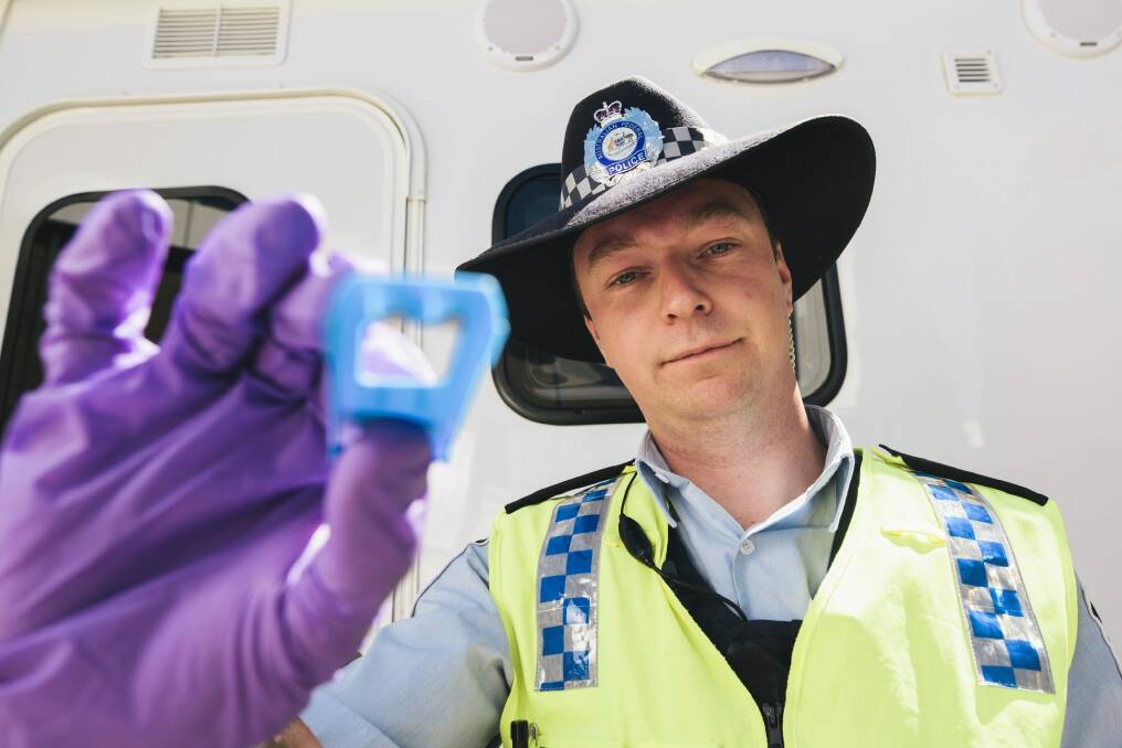 ACT Policing Constable Ashley Knowles with a saliva swab used in random roadside drug tests.  Photo: Rohan Thomson