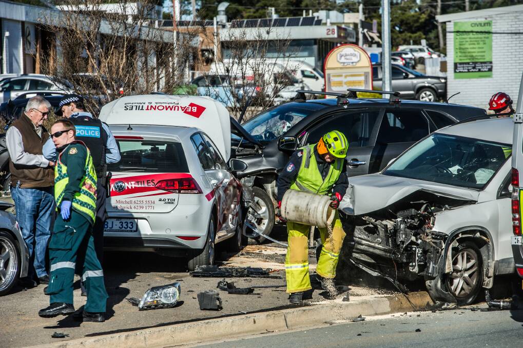 Firefighters work at the scene of a four-car crash in Fyshwick on Wednesday morning. Photo: Karleen Minney