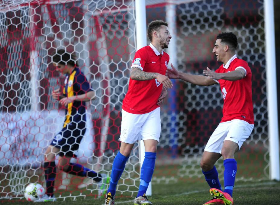 Double strike: Canberra FC striker Thomas James celebrates his second goal with team-mate Josip Jadric in Sunday's 3-0 win against the FFA Centre of Excellence. Photo: Melissa Adams 