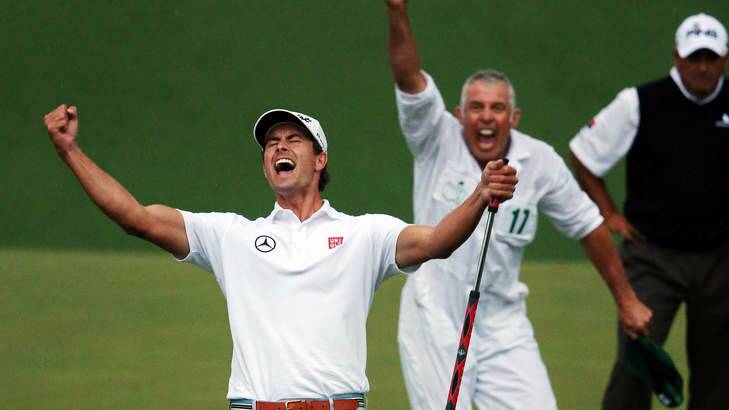 Adam Scott reacts alongside caddie Steve Williams after Scott makes a birdie putt on the second sudden death playoff hole. Photo: Andrew Redington/Getty Images