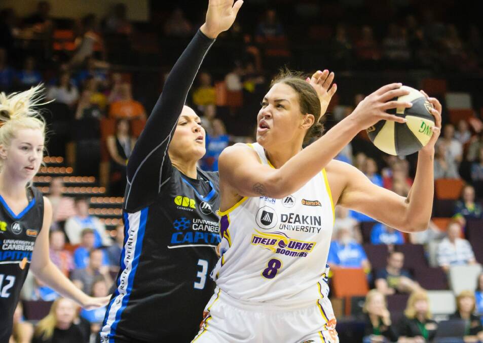 Capitals forward Mistie Bass tries to defend against Boomers centre Liz Cambage on Sunday. Photo: Sitthixay Ditthavong