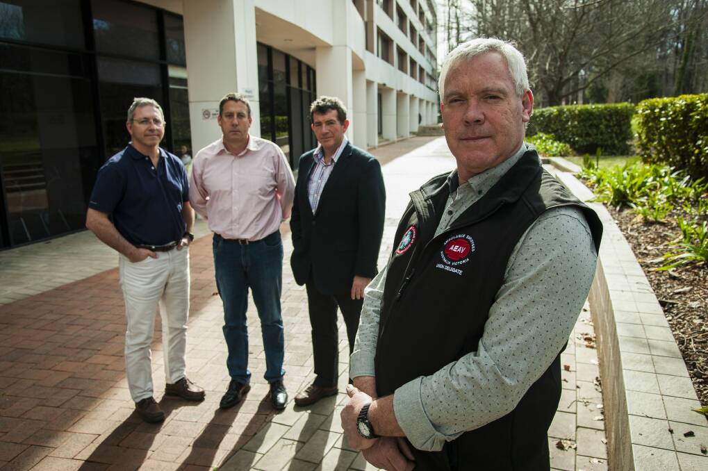 ACT ambulance service intensive care paramedics Jim Arneman, Justin Hockley and Steve Mitchell, with National Council of Ambulance Unions president Steve McGhie, are angry nothing has been done about reforms. Photo: Elesa Kurtz