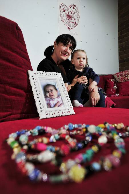 Suzanne Tunks with her daughter Ruby Tunks-Frawley a photo of her late daughter Stella in 2013. Photo: Jay Cronan