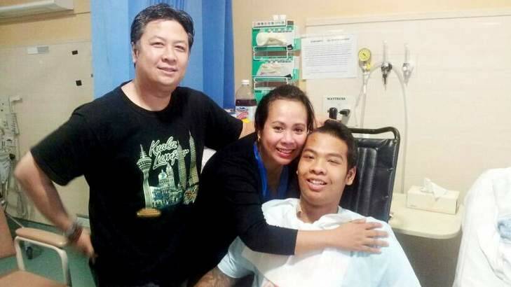 Kyah "Burma" Han with his parents in hospital, recovering from the hit and run. Photo: Jay Cronan