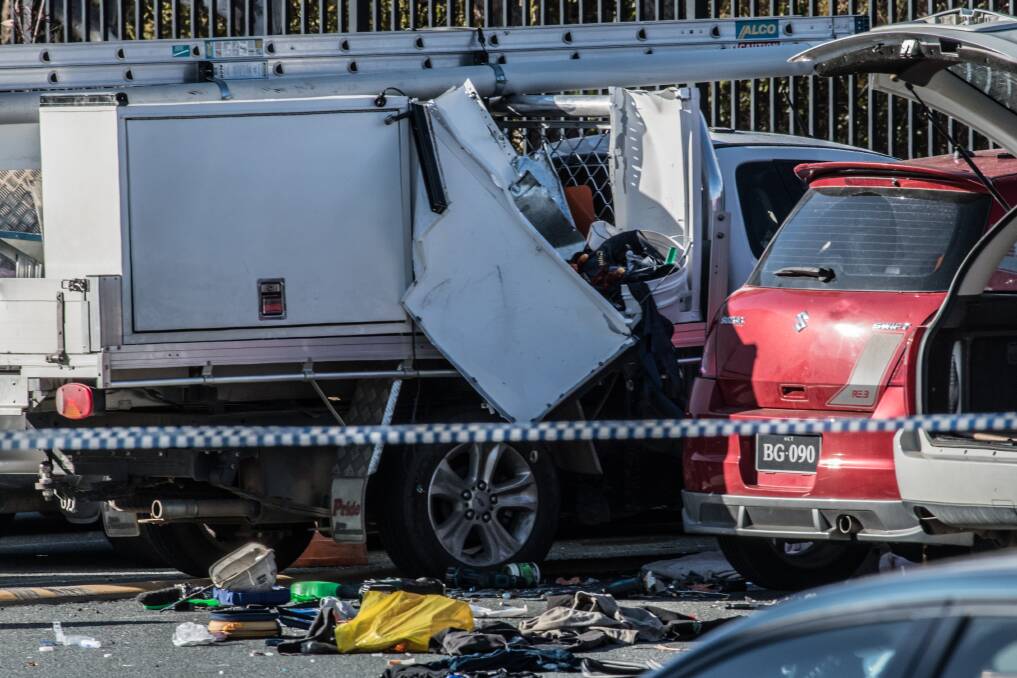 A damaged ute in the car park at St Clare of Assisi Primary School in Conder on Friday, the day after a fatal explosion blamed on a leaking gas bottle. Photo: Karleen Minney