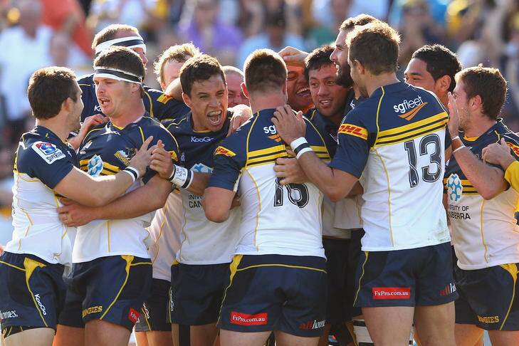Christian Lealiifano of the Brumbies celebrates with team mates after kicking the winning penalty goal. Photo: Cameron Spencer
