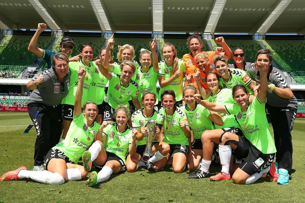 Canberra players and coaching support staff celebrate winning the 2014 W-League Grand Final. Photo: Getty Images