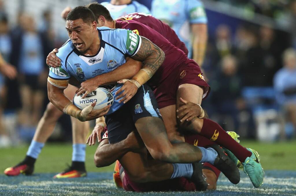 Top show:  Blues forwrad Tyson Frizell is tackled during game three of the State Of Origin series between NSW and the Queensland Maroons at ANZ Stadium. Photo: Ryan Pierse