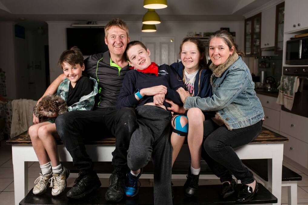 The McCarthy family is among those affected by the closure of respite services for people with high needs in Canberra. 16-year-old Logan has autism and requires one-on-one care. From left, Logans therapy dog Simi, Kellan 9, Jason, Logan 16, Jenna 14, and Lucy. Photo: Jamila Toderas Photo: Jamila Toderas