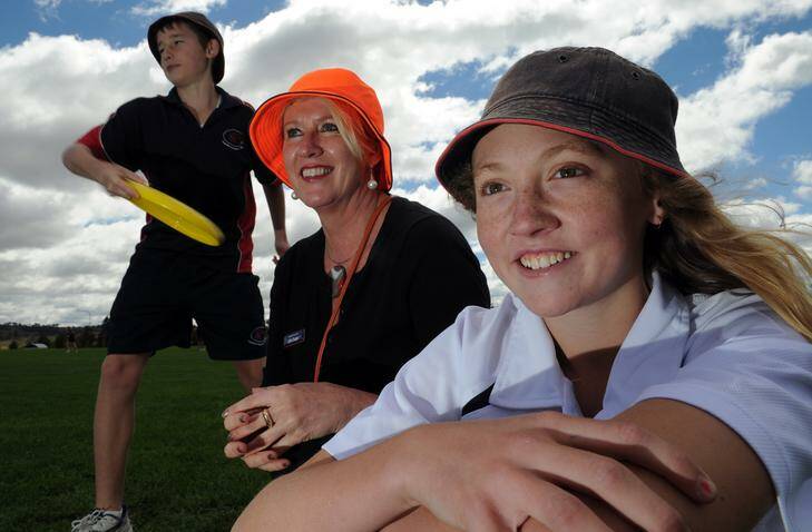 Amaroo School year 8 students, Luke Hall, left and Maddison McGarry with Deputy Principal, Julie Cooper with their colourful bucket hats. Photo: Graham Tidy