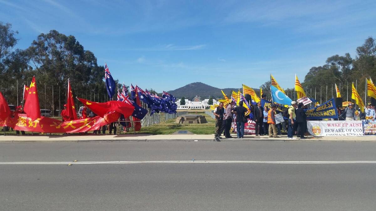 Peaceful: Protesters and supporters gathered outside Parliament House as Chinese President Xi Jinping visited Canberra on Monday. Photo: Megan Gorrey
