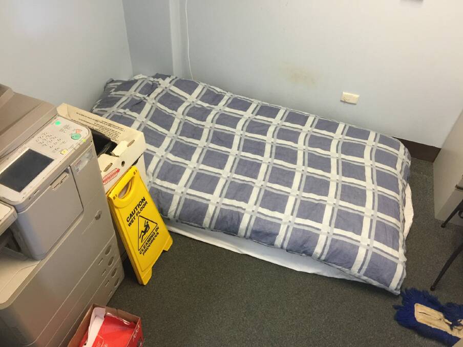 Exhausted firefighters are sleeping on the floor in an office next to a noisy printer.  Photo: Supplied