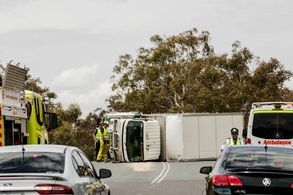 The truck tipped on its side, causing a closure for the Monaro Highway exit onto Old Cooma Road, Royalla. Photo: Jamila Toderas