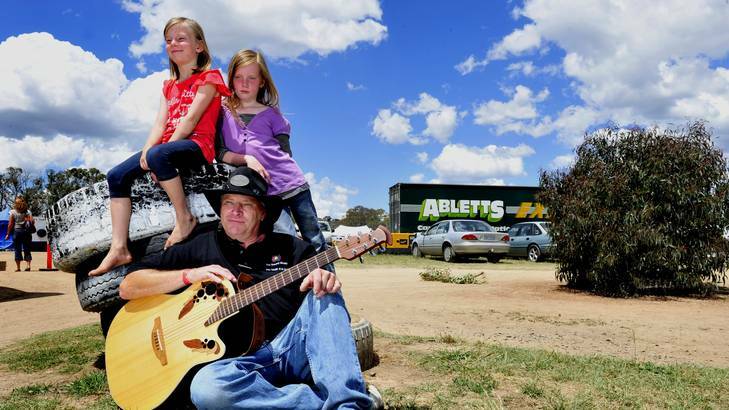 Guitarist Ian Wholohan of Jerrabomberra with his daughters, Samantha,7, and Rachel, 9. Photo: Melissa Adams