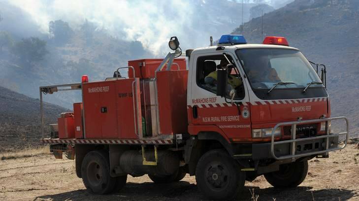 A fire truck watches over the fire on a property off Childowla Road. Photo: Graham Tidy